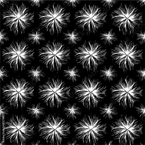 Seamless pattern of stylized white floral shapes on a black background with varying sizes and densities