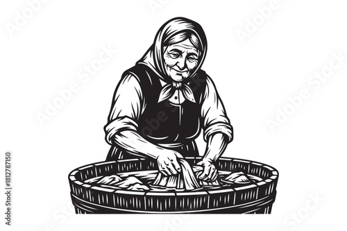 Elderly woman washing clothes in a wooden tub
