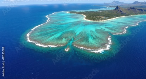 Fototapeta Naklejka Na Ścianę i Meble -  Aerial view of a tropical island lagoon. Vibrant turquoise water surrounds a coral reef, forming a unique island shape. A light-colored beach is visible on the island