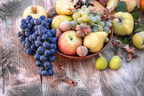 Seasonal fruit, autumn organic fruit in bowl on table, autumn still life