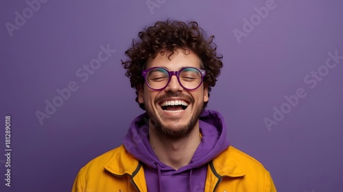 Vibrant portrait of a joyful young adult wearing colorful clothing and stylish glasses, captured against a bold purple background with expressive laughter and energetic modern fashion vibes