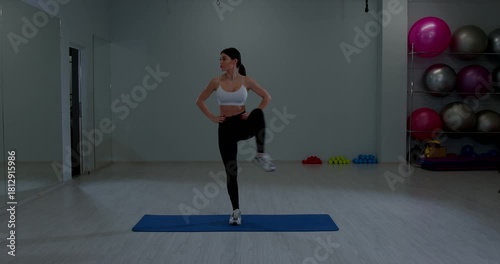 Athletic Female Doing High Knee Lifts Workout Session Indoors Fitness Center Training Healthy Body