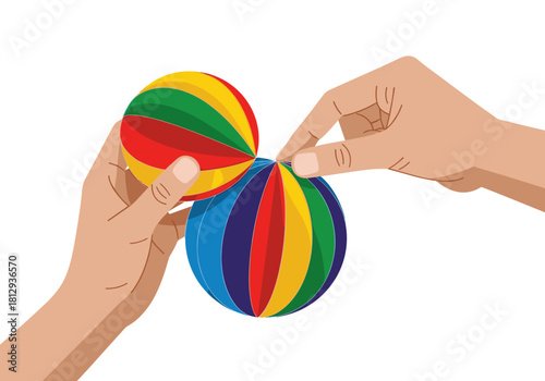 Two hands assembling colorful paper honeycomb ornament for Christmas and New Year  