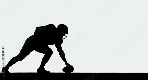 Powerful silhouette of a football player ready for kickoff, capturing the intensity and athleticism of the sport, perfect for sports publications and marketing