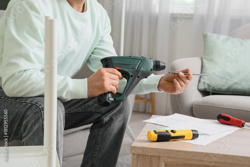 Man with drill assembling s...