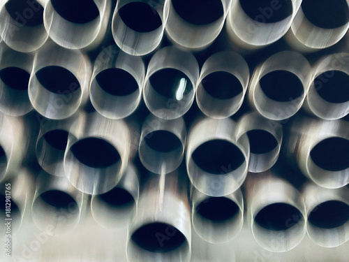 Close-up blurry abstract Background of Stacked Grey PVC Pipes in a Geometric Pattern