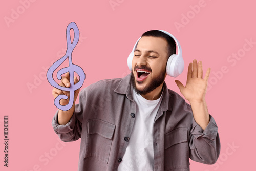 Singing young man in headph...