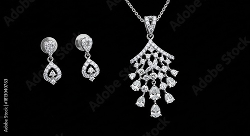Elegant pendant and earring set with shimmering diamonds, against a deep black backdrop