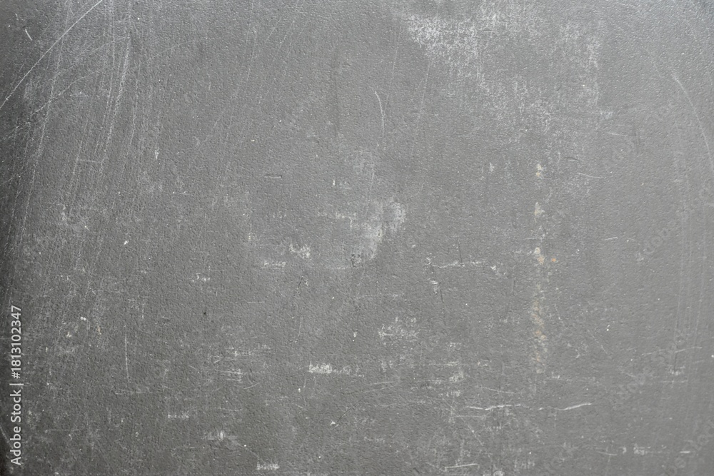 Naklejka premium Light grey concrete wall with subtle distress marks and natural wear, making it a versatile industrial or architectural background.
