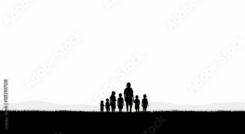 Silhouette of a family standing together on a grassy field.