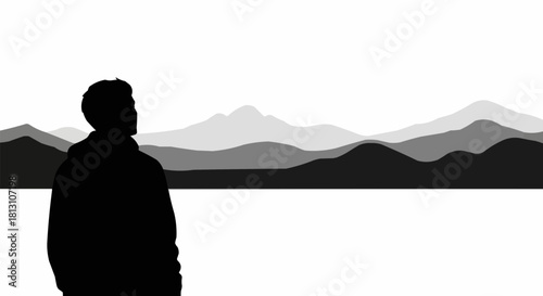 Silhouette of a man looking towards the horizon in contemplation.
