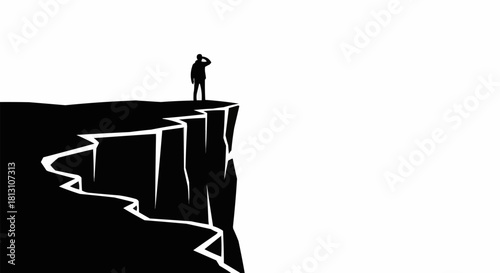 Silhouette of a man standing on a cliff edge looking out into the distance.