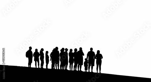 Black silhouette of a diverse group of people standing on a hill.