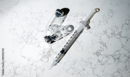 Close up of Single Use Syringe with Small Glass Vials