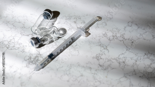 Close up of Single Use Syringe with Small Glass Vials