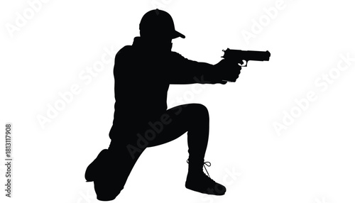 Silhouette of a police officer or soldier kneeling while aiming a handgun with both hands