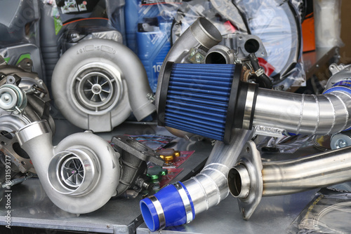 Powerful collection of car engine parts for custom automotive upgrade. This assortment of performance turbocharger, intake, and exhaust components ready for high speed tuning