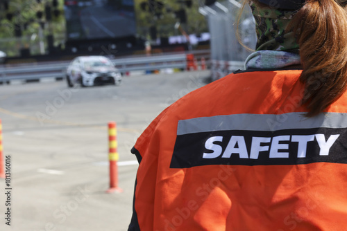 Tableau sur toile Professional safety officer woman in an orange vest showing vigilance