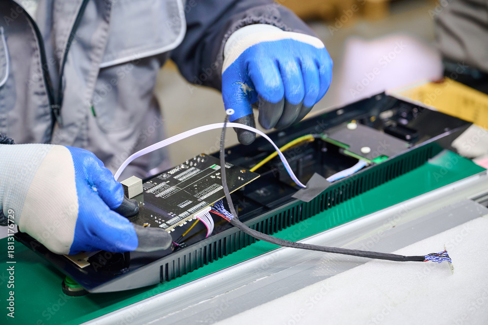 Obraz premium PCB assembly process inside a plastic housing during electronics manufacturing with precision and care