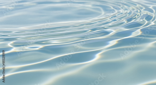 Close-up of clear pale blue water ripples reflecting bright sunlight