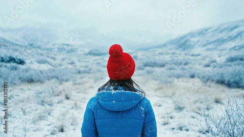 Woman in blue jacket and red hat