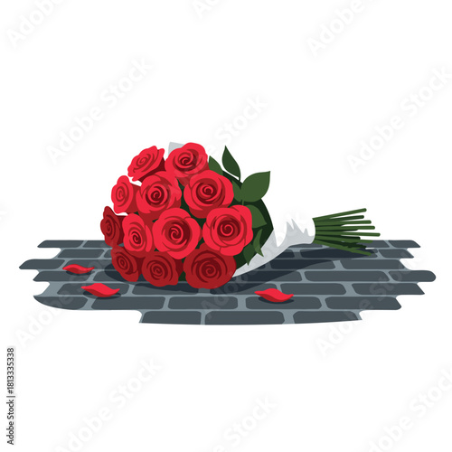 Forgotten bouquet of vibrant red roses with scattered petals lying abandoned on a dark gray cobblestone street after an event.