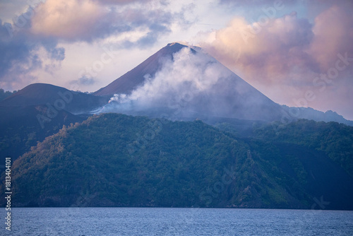 Barren Island Volcanic Cone Emitting Smoke Over Dark Forest Slopes