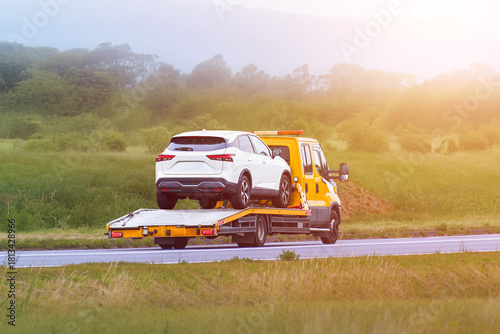 White car on flatbed after breakdown