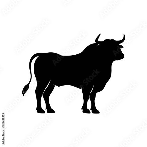 A black silhouette of a standing bull with curved horns and a long tail, isolated on a white background.