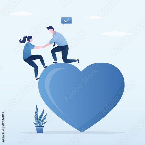 Confident man helping friend to climb on big heart shape. Woman and a man find love. Mentor teaches positive thinking and love for others.