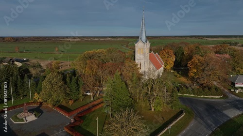 Aerial footage of one of the oldest churches in Estonia - Church of the Blessed Virgin Mary in Joelahtme (Estonian - Püha Neitsi Maarja kirik, Jõelähtme) on a sunny autumn day. 