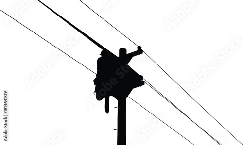 Silhouette of lineman working on power lines