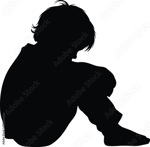 Sad child silhouette sitting alone