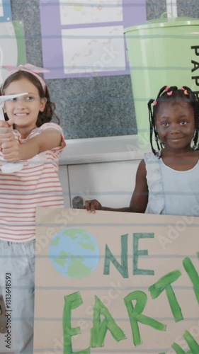 Children holding recycling signs and bags over environmental awareness animation