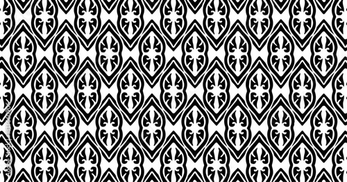 Decorative ornamental pattern with vertical oval motifs in black and white creating a repeating structure.
