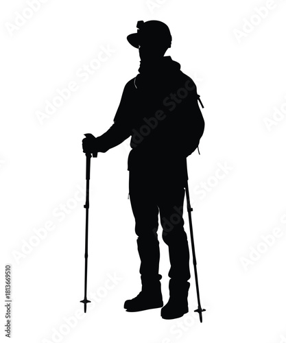 A lone hiker stands with trekking poles captured in a stark black silhouette against a white background representing adventure and outdoor exploration silhouette