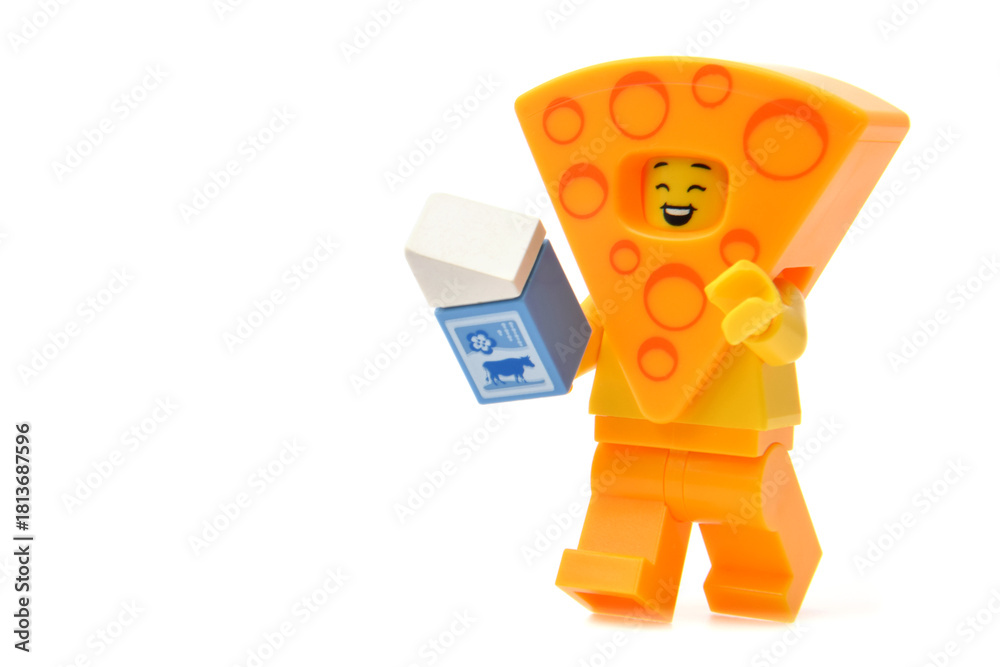 Naklejka premium Editorial illustrative image of lego minifigure of yellow cheese isolated on white.