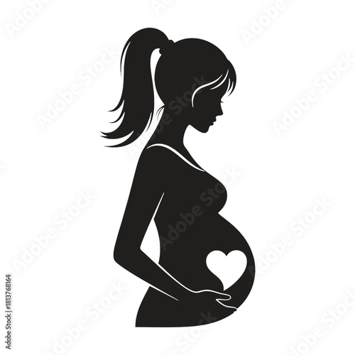 Silhouette of a pregnant woman gently cradling her baby bump with love