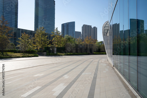 modern city scene with tall glass buildings and green trees