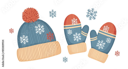 Knitted winter hat with pompom and a pair of matching mittens adorned with snowflakes, cozy cold weather apparel.