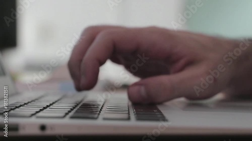 close up of a man typing on a keyboard