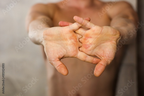 Obraz na plátně Muscular man performing finger interlock stretch with palms facing out