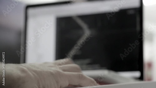 a man coding with a blurred background