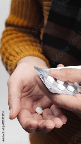 A person shows a pack of medication ready to take the pills inside