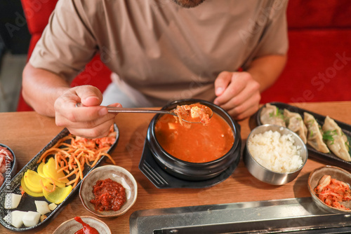 Close-up of traditional Korean kimchi jjigae soup with tofu in a Korean restaurant. Asian food. global food culture