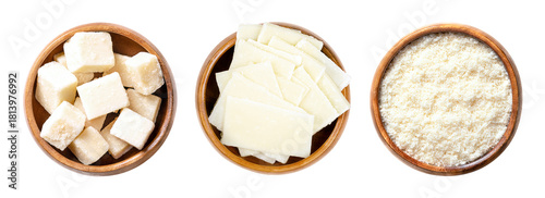 Grana Padano cheese, Italian hard cheese, in wooden bowls. Block shaped chunks, thin slices, and grated cheese, similar to Parmesan, with crumbly and slightly gritty texture, and strong savory flavor.