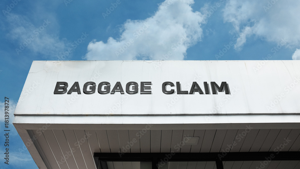 Obraz premium Baggage Claim word sign displayed on building under clear blue sky, representing airport services, luggage handling, travel, and passenger facilities