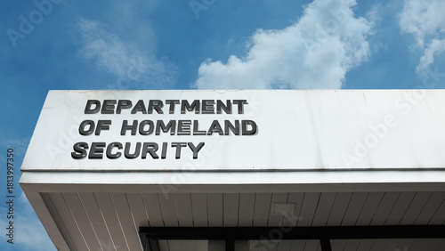 Department of Homeland Security word sign on a building under a clear blue sky, symbolizing national security, government policy, protection, and emergency services