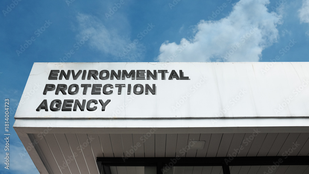 Fototapeta premium Environmental Protection Agency sign displayed on a building against a clear blue sky, symbolizing regulation, conservation, public health, climate policy, and governmental oversight