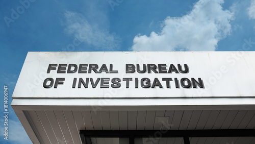 Federal Bureau of Investigation sign displayed on a building against a clear blue sky, symbolizing law enforcement, national security, intelligence, government agency, and justice